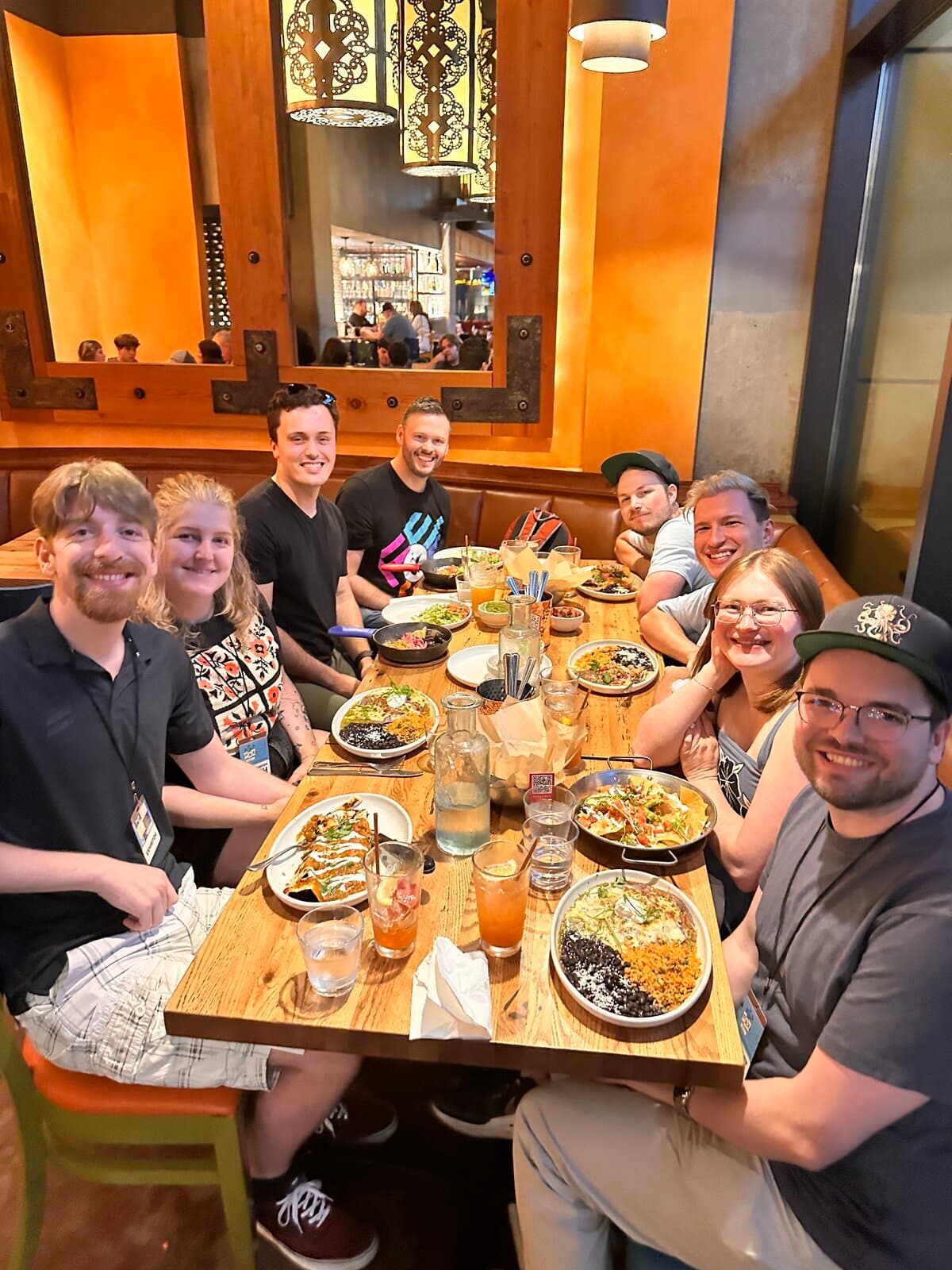 The whole Snowfall Games team crowded around a long restaurant table after the show, plates and drinks everywhere