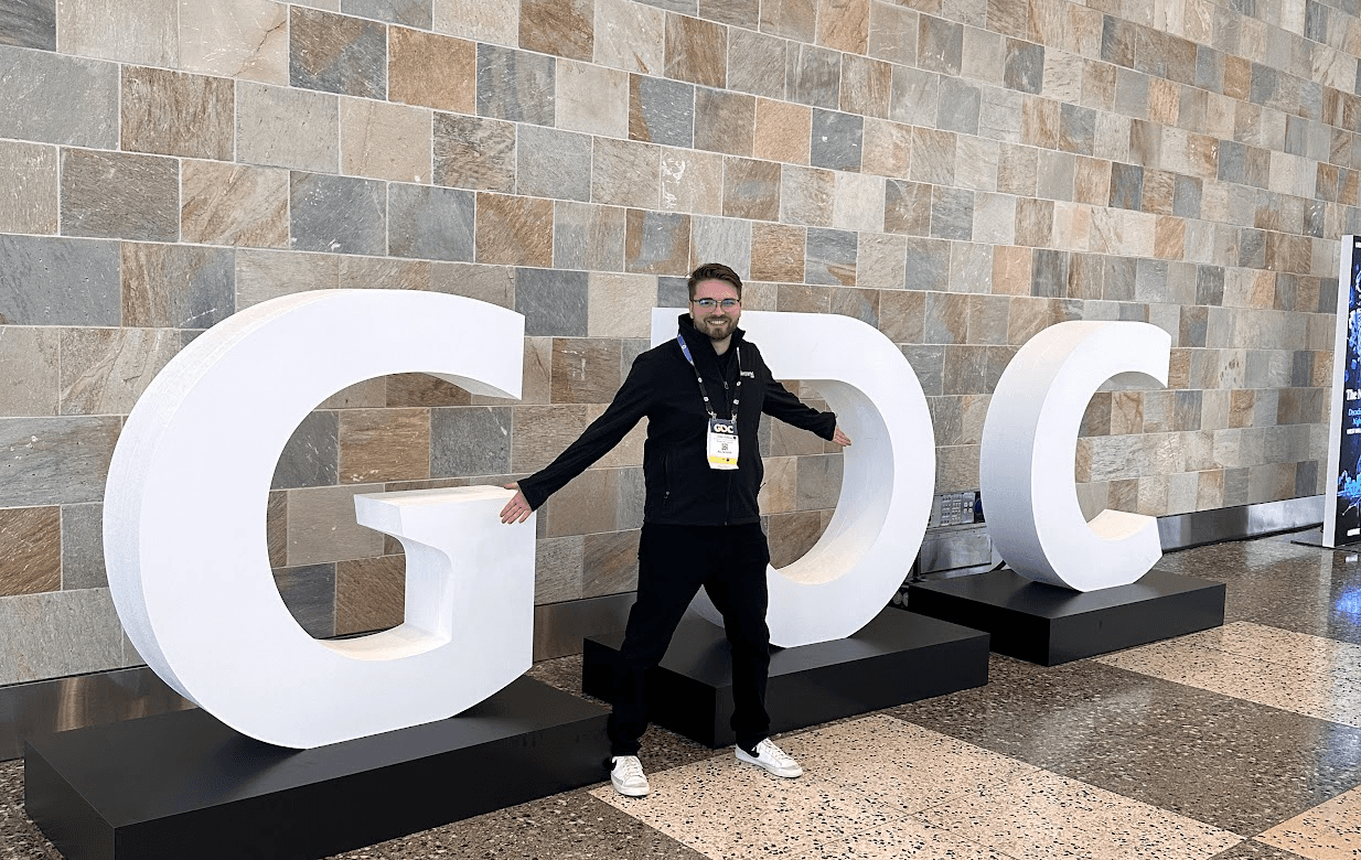 Jaden standing with the GDC sign at the Game Developers Conference
